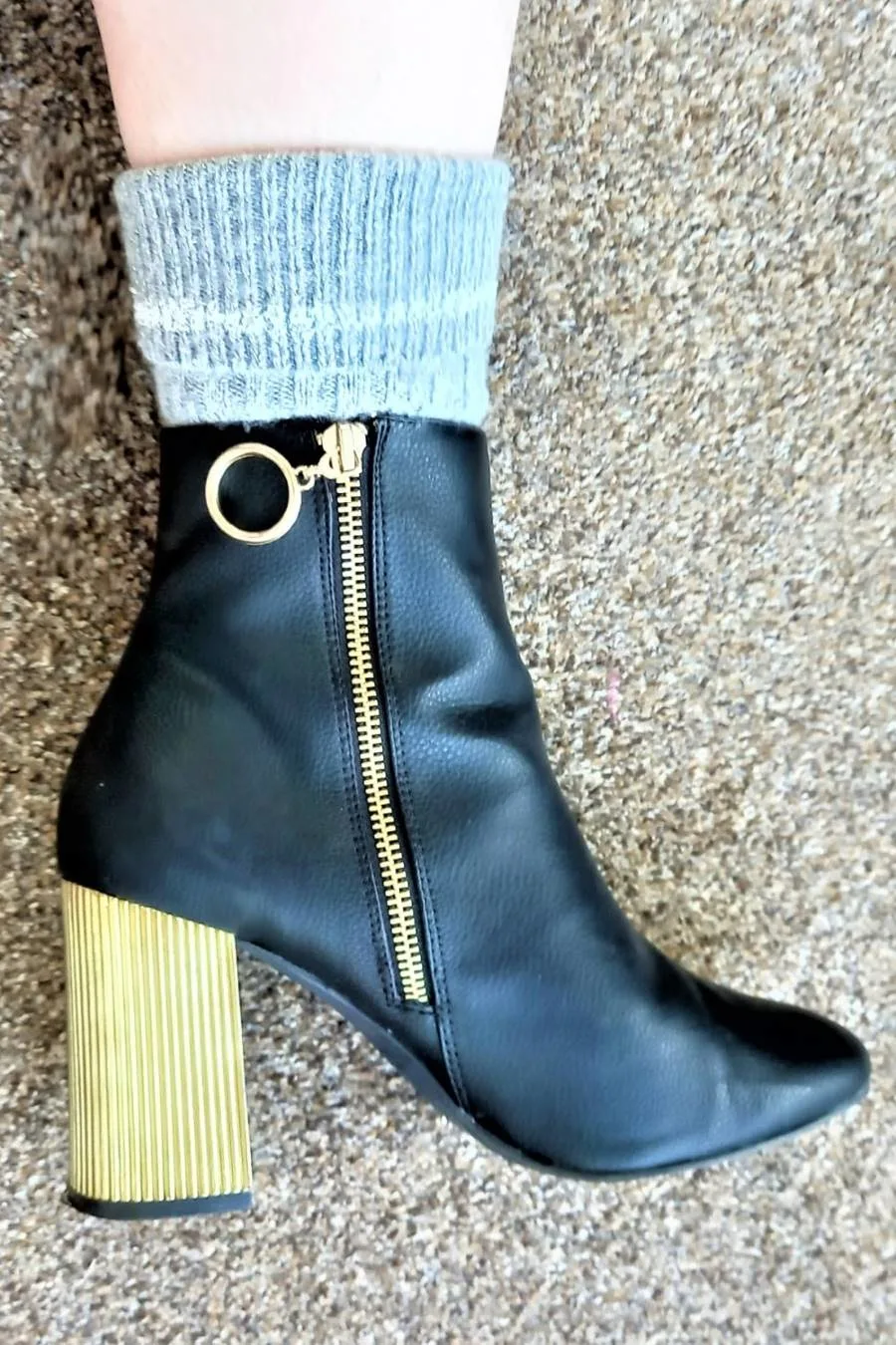 Black boot and grey wool socks