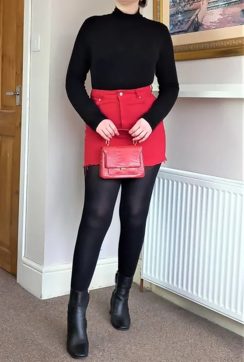Black turtleneck and red denim skirt