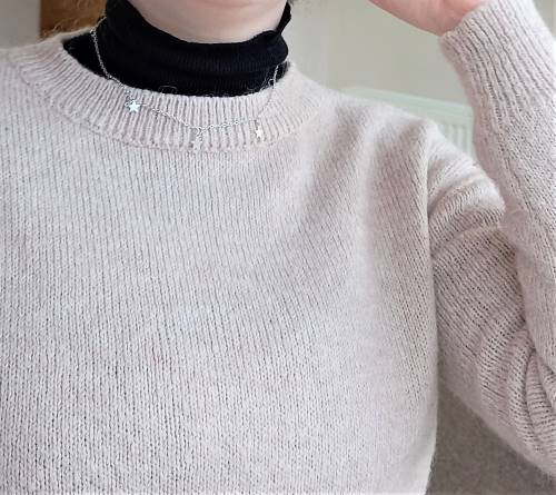 Necklace layered over turtleneck
